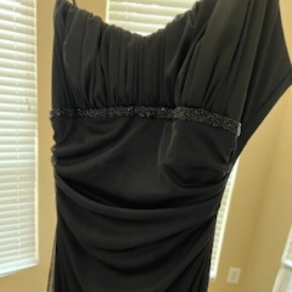 Black formal girls dress with multiple layers of sheer ruffles at the bottom. - Picture 1 of 7